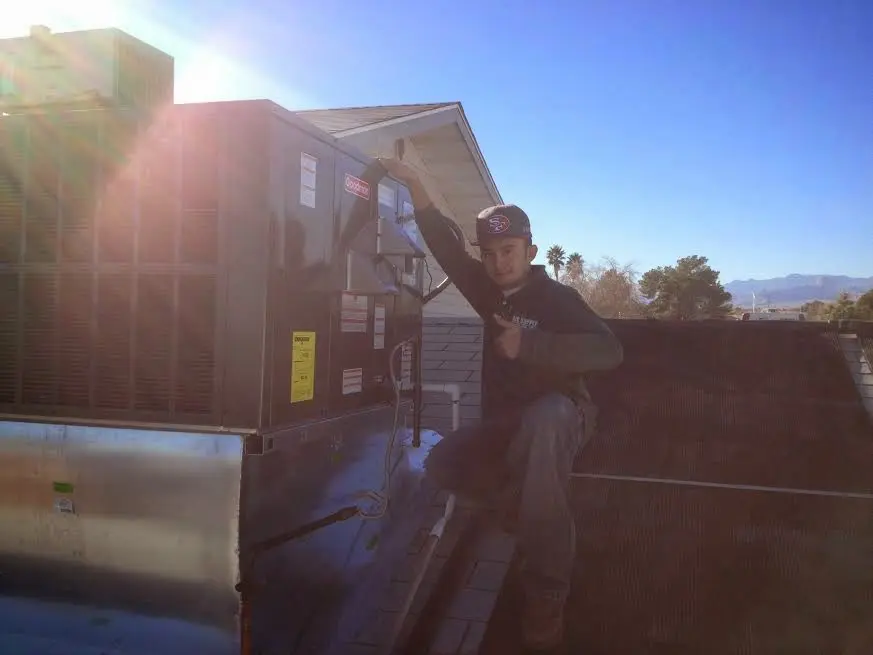 HVAC technician performing AC Tune-Up on a rooftop unit in Casselberry